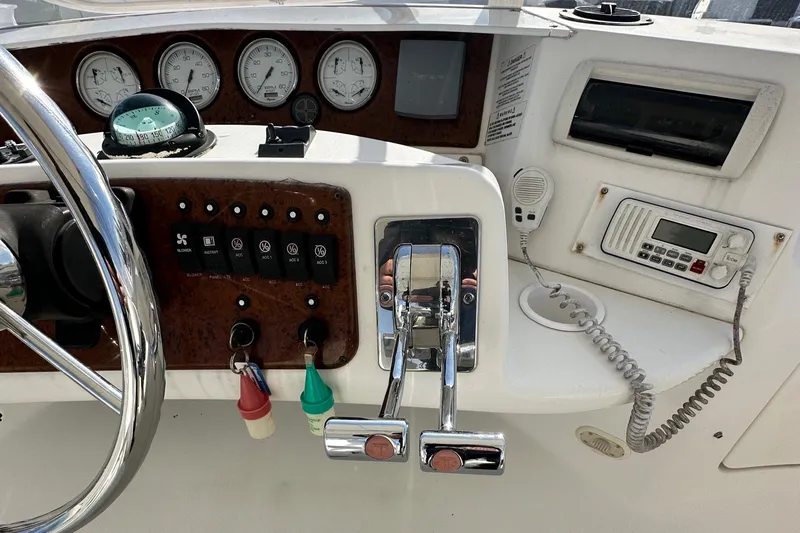 Slide: The Image of Control panel of a 2005 Silverton 34 Convertible boat with gauges and radio. - 5