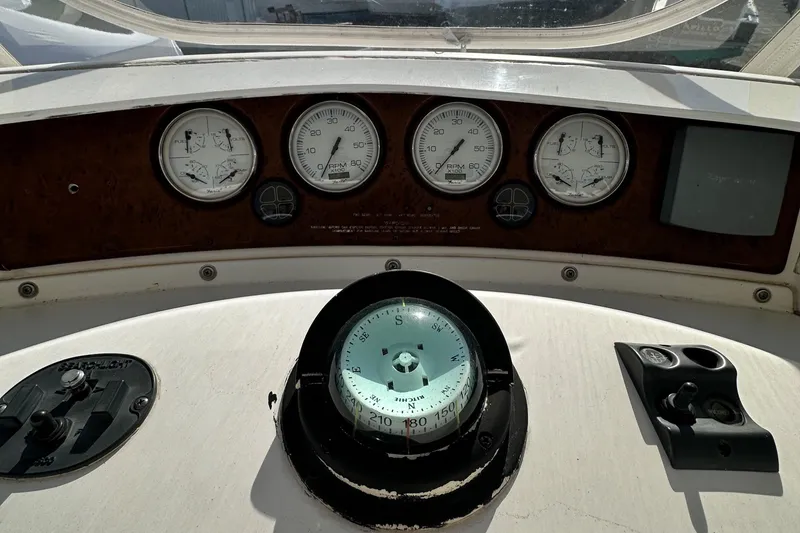 Slide: The Image of Control panel of 2005 Silverton 34 Convertible boat with compass and gauges. - 8