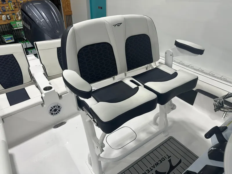 Slide: The Image of 2025 Tidewater 2500CB boat interior with dual black and white cushioned seats. - 20