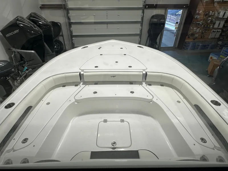 Slide: The Image of 2025 Tidewater 2500CB boat interior with spacious seating and storage compartments. - 23