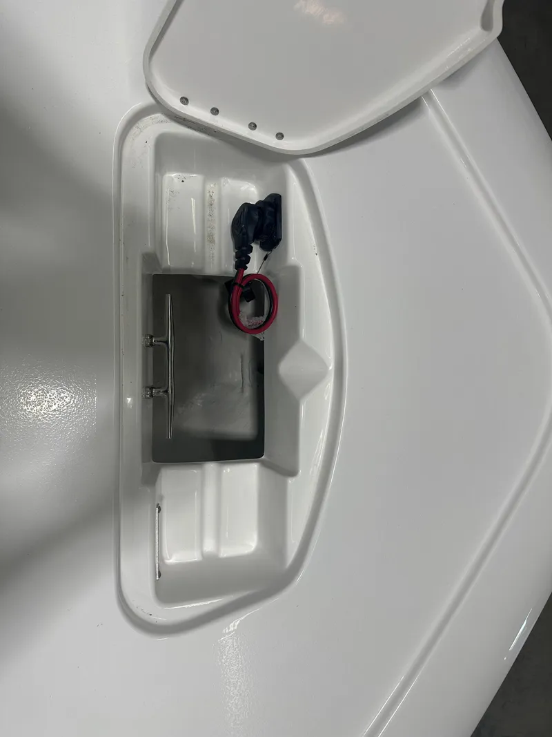 Slide: The Image of 2025 Tidewater 2500CB boat compartment with open hatch and wiring. - 28