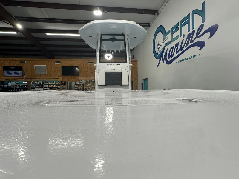 Slide: The Image of 2025 Tidewater 2500CB boat displayed at Ocean Marine Group showroom. - 3