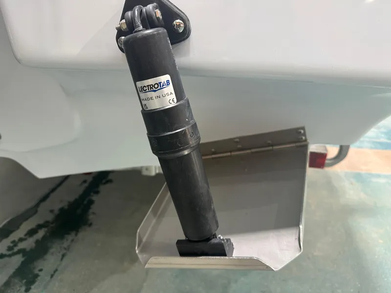 Slide: The Image of Tidewater 2500CB 2025 boat trim tab with Lectrotab actuator, close-up view. - 6