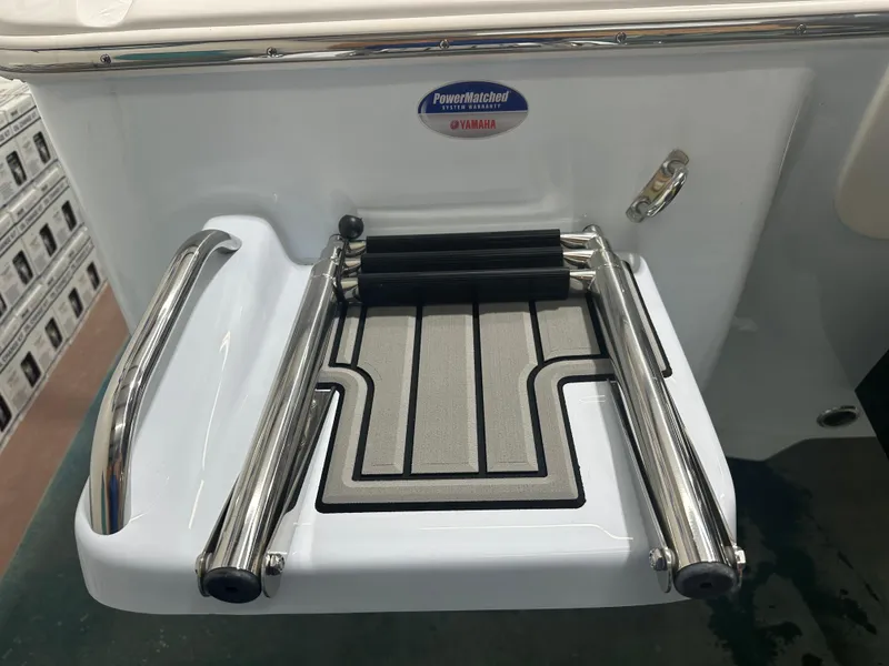 Slide: The Image of Tidewater 2500CB 2025 boat swim platform with stainless steel ladder and Yamaha warranty badge. - 7