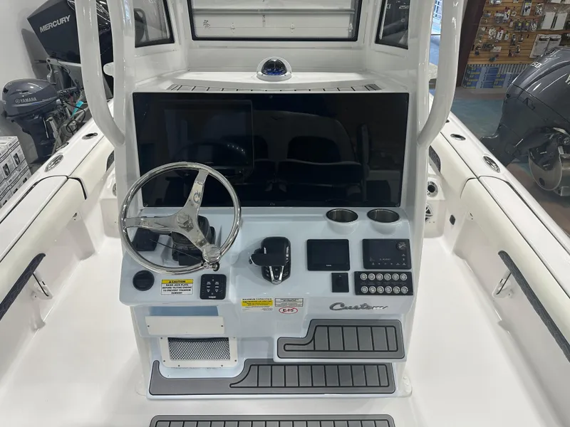 Slide: The Image of 2025 Tidewater 2500CB boat console with steering wheel and control panel. - 8
