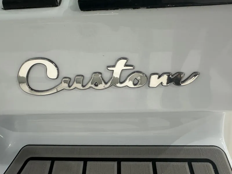 Slide: The Image of Chrome "Custom" emblem on 2025 Tidewater 2500CB boat. - 9