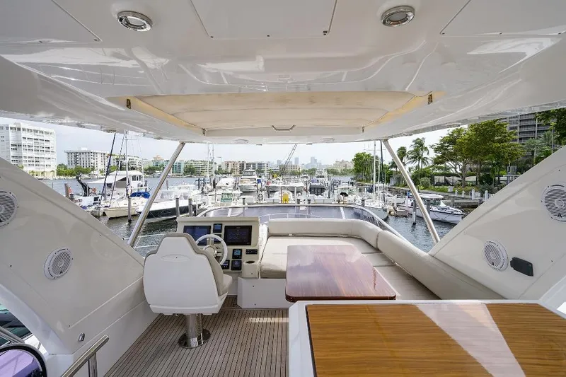 Slide: The Image of Luxurious 2016 Azimut 50 yacht interior with marina view, featuring helm and seating area. - 21