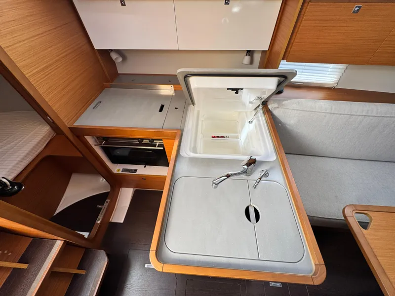 Slide: The Image of Modern kitchen area in 2021 Dufour 360 sailboat with sink and storage. - 11