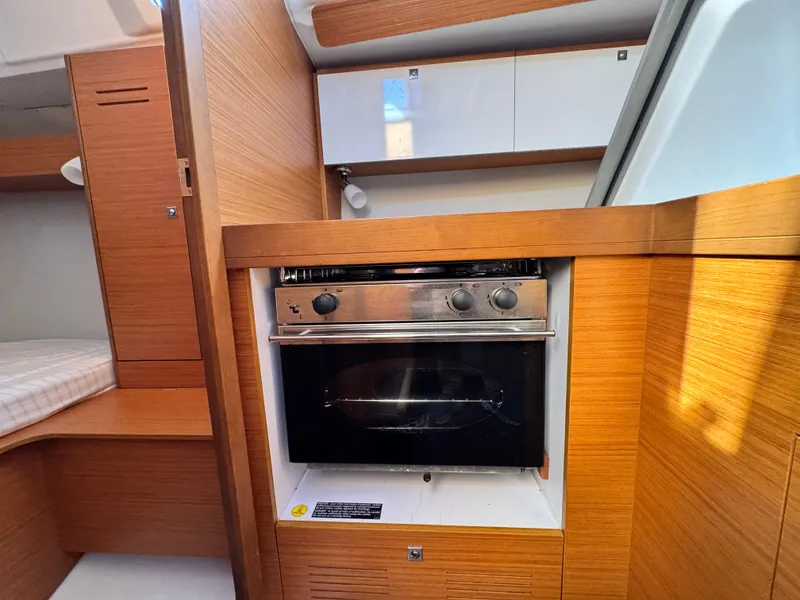 Slide: The Image of 2021 Dufour 360 yacht interior with modern kitchen and wood finish. - 12