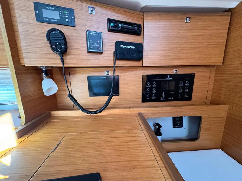 Slide: The Image of Dufour 360 yacht interior control panel, 2021 model, featuring navigation and communication equipment. - 17