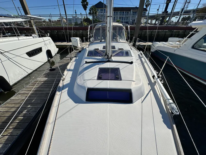 Slide: The Image of 2021 Dufour 360 sailboat docked at marina, showcasing sleek deck design. - 18