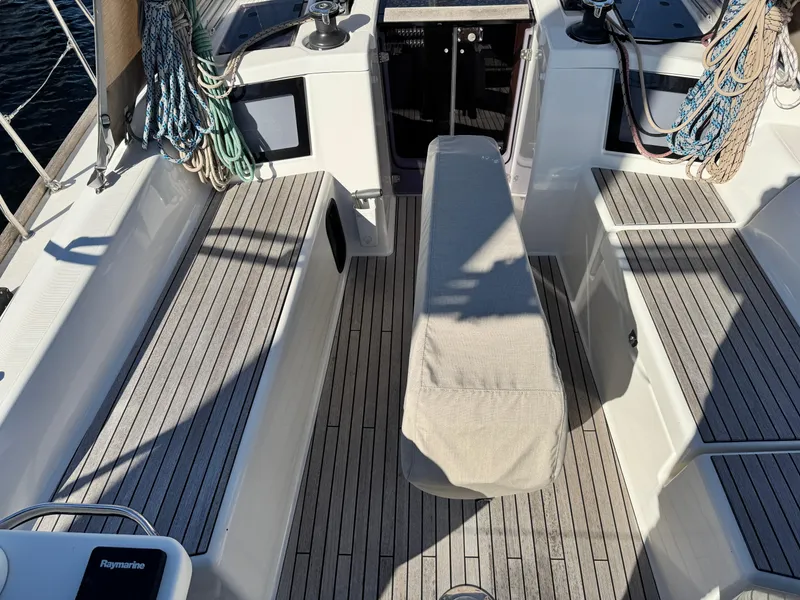 Slide: The Image of Dufour 360 sailboat cockpit, 2021 model, featuring teak flooring and covered seating. - 2