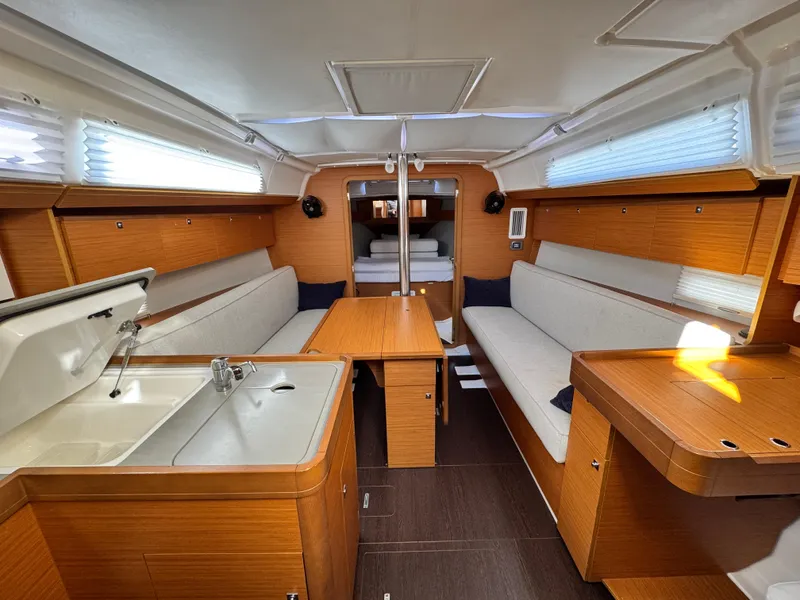Slide: The Image of Interior of 2021 Dufour 360 sailboat with wood finish and cozy seating area. - 4
