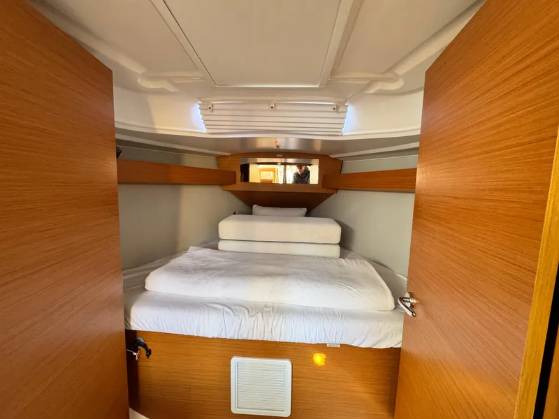 Slide: The Image of Interior cabin of 2021 Dufour 360 yacht with cozy bed and wooden finish. - 9