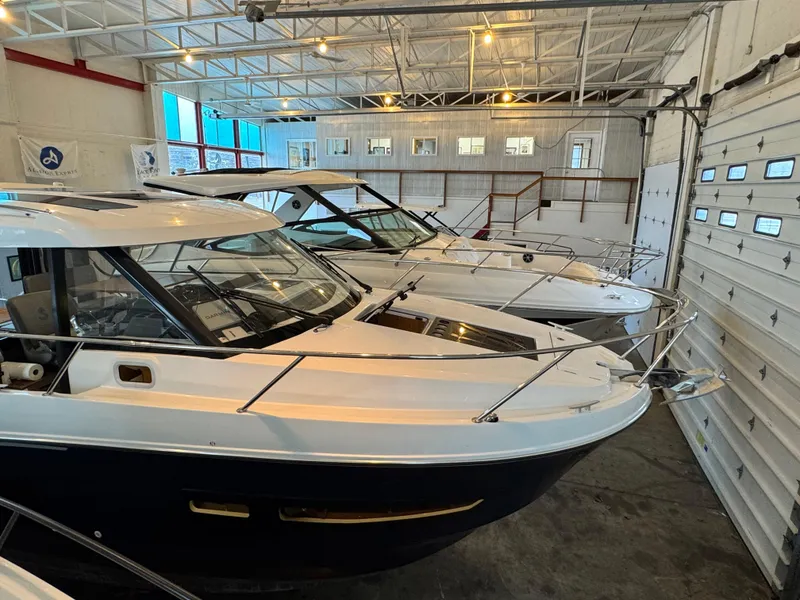 Slide: The Image of 2022 Beneteau Antares 9 boat hull in indoor storage on stands. - 2