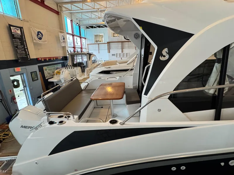 Slide: The Image of 2022 Beneteau Antares 9 boats in a well-lit indoor storage facility. - 4