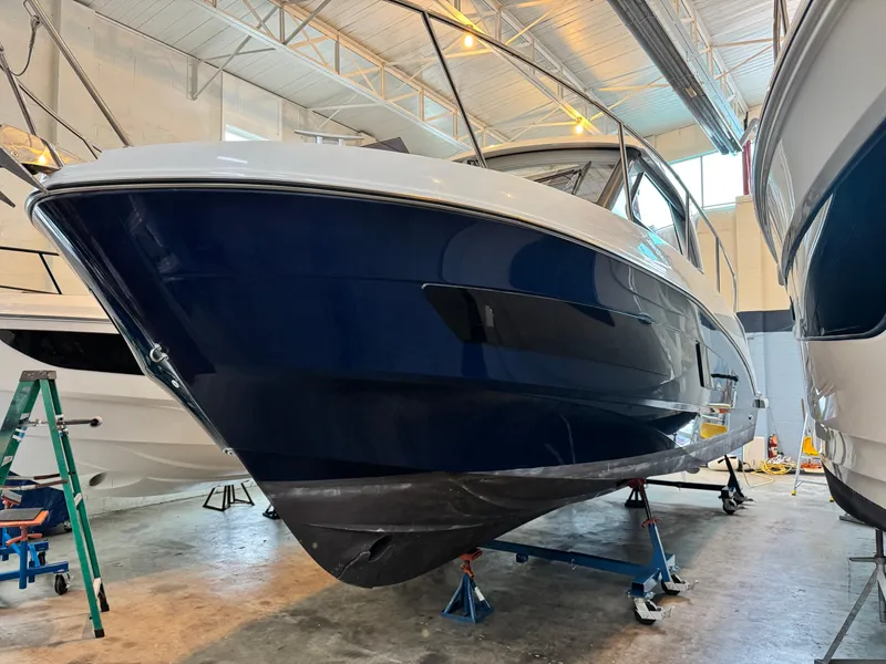 Slide: The Image of 2022 Beneteau Antares 9 boat in a showroom, showcasing sleek design and modern features. - 5