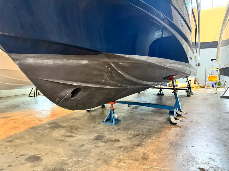 Slide: The Image of 2022 Beneteau Antares 9 boat interior with seating and table in showroom. - 6