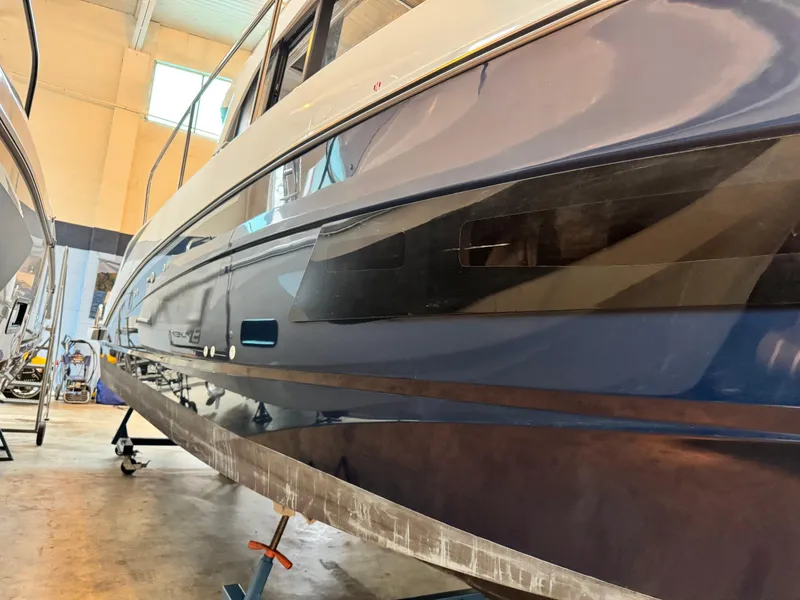 Slide: The Image of 2022 Beneteau Antares 9 with twin Mercury engines, featuring a spacious deck and seating area. - 9