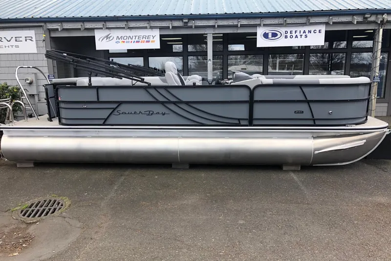 Slide: The Image of 2023 South Bay 222CR LE 2.75 pontoon boat displayed outside dealership. - 3