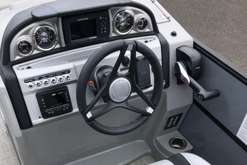 Slide: The Image of 2023 South Bay 222CR LE 2.75 boat dashboard with steering wheel and controls. - 5