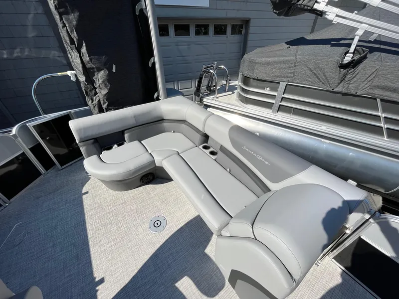 Slide: The Image of 2023 South Bay 222CR LE 2.75 pontoon boat with gray seating and spacious deck. - 6