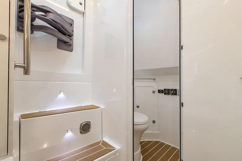 Slide: The Image of 2021 HCB 42 Lujo boat interior bathroom with modern fixtures and wood accents. - 10