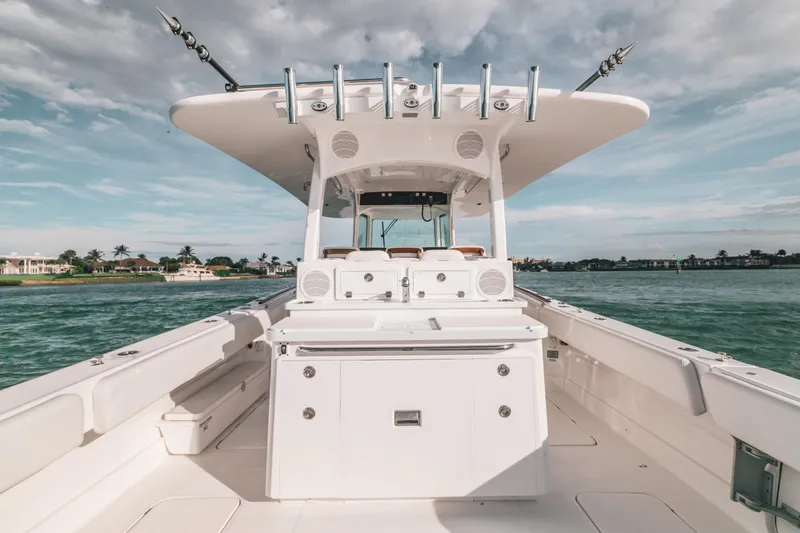 Slide: The Image of 2021 HCB 42 Lujo boat on water, showcasing spacious deck and sleek design. - 2