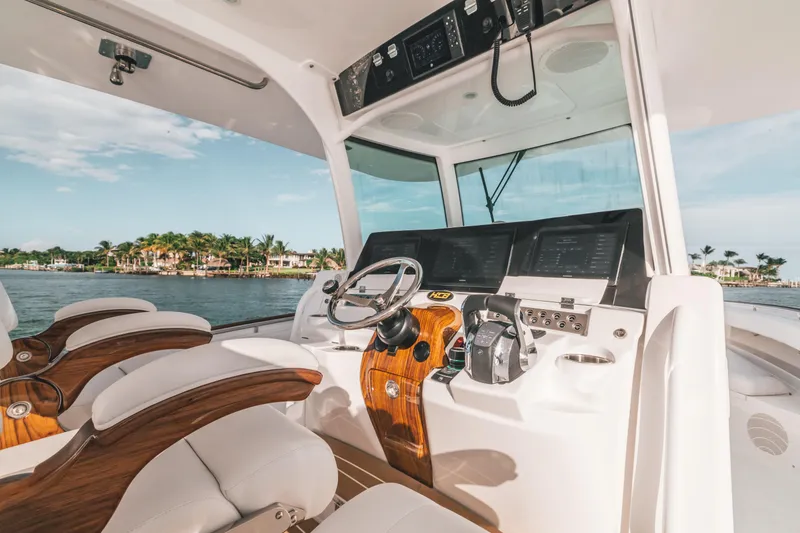 Slide: The Image of 2021 HCB 42 Lujo boat cockpit with modern controls and luxurious seating. - 6