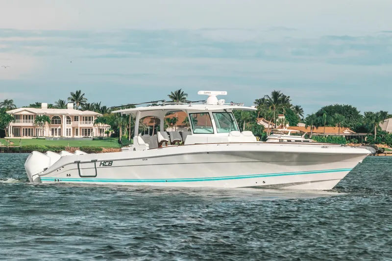 Slide: The Image of 2021 HCB 42 Lujo boat cruising on a scenic waterway. - 8