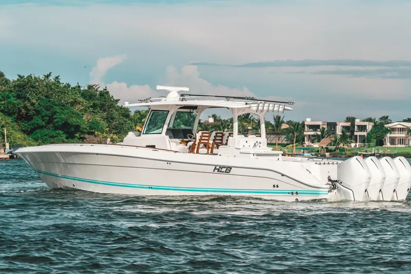 Slide: The Image of 2021 HCB 42 Lujo boat cruising on a scenic waterway. - 9