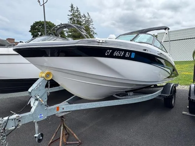 Slide: The Image of 2017 Yamaha Boats SX195 on trailer, parked outdoors, overcast sky. - 0