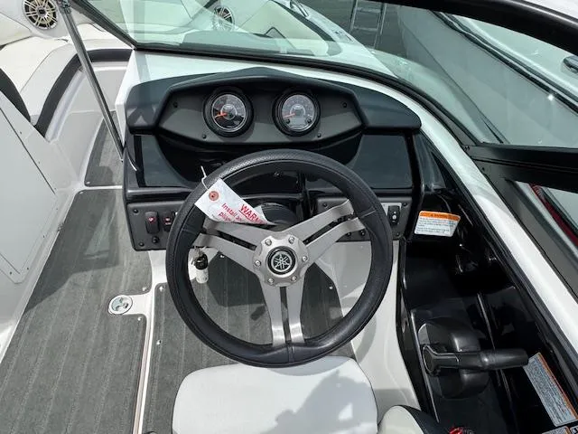Slide: The Image of 2017 Yamaha Boats SX195 dashboard with steering wheel and gauges. - 12