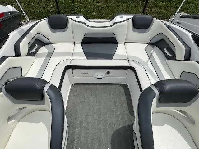 Slide: The Image of 2017 Yamaha Boats SX195 interior with white and gray seating, spacious and modern design. - 15