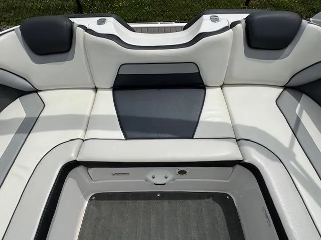 Slide: The Image of 2017 Yamaha Boats SX195 interior seating with white and black upholstery. - 17