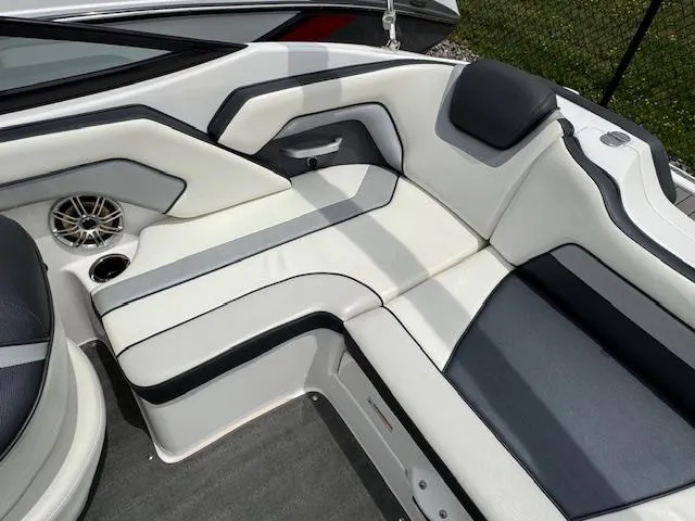 Slide: The Image of 2017 Yamaha Boats SX195 interior seating with sleek white and gray upholstery. - 18