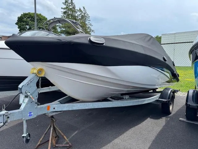Slide: The Image of 2017 Yamaha Boats SX195 on trailer, covered, parked outdoors. - 2