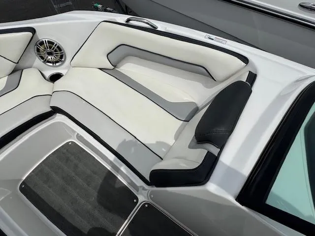 Slide: The Image of 2017 Yamaha Boats SX195 interior with white and black seating, speaker, and cup holder. - 7