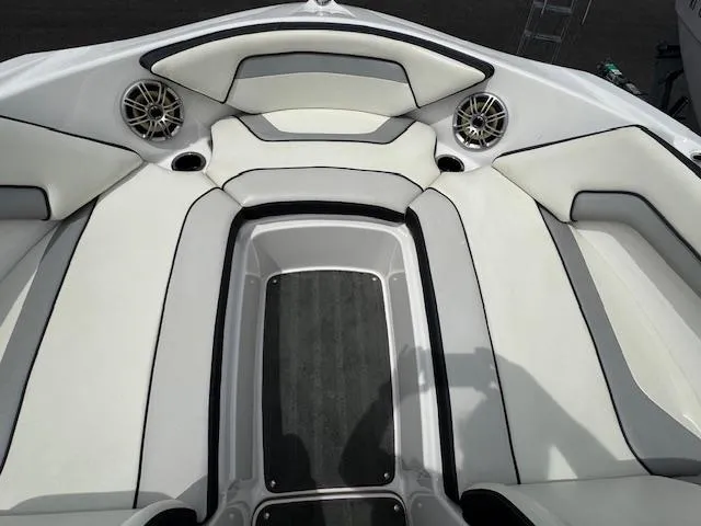Slide: The Image of 2017 Yamaha Boats SX195 interior with white cushioned seating and built-in speakers. - 8