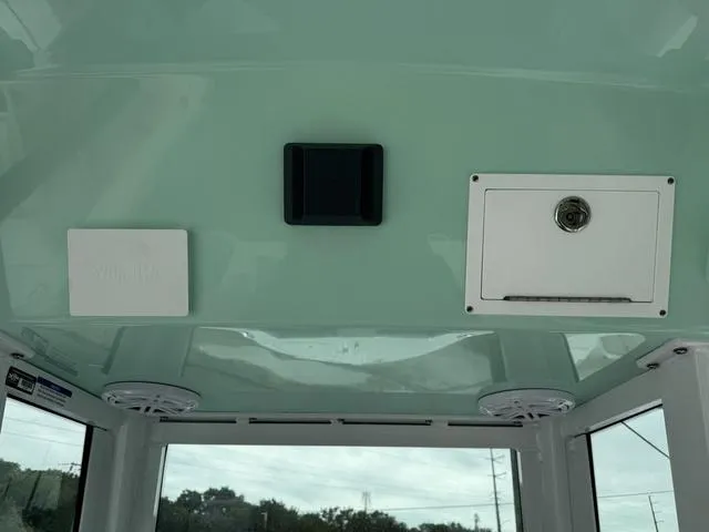 Slide: The Image of 2025 Wellcraft 223 Fisherman boat interior ceiling with speakers and storage compartments. - 12