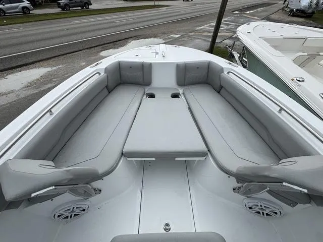 Slide: The Image of 2025 Wellcraft 223 Fisherman boat interior with gray seating and spacious layout. - 13