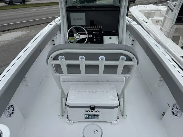 Slide: The Image of 2025 Wellcraft 223 Fisherman boat interior with steering console and Igloo cooler. - 6