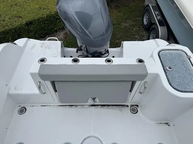 Slide: The Image of 2025 Wellcraft 223 Fisherman boat stern with motor and seating area. - 7