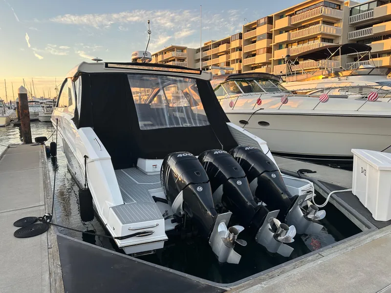 Slide: The Image of 2021 Cruisers Yachts 42 GLS OB docked with triple outboard engines. - 13