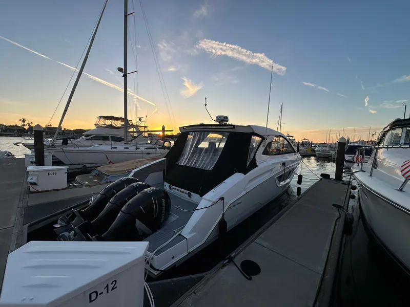 Slide: The Image of 2021 Cruisers Yachts 42 GLS OB docked at sunset in marina. - 16