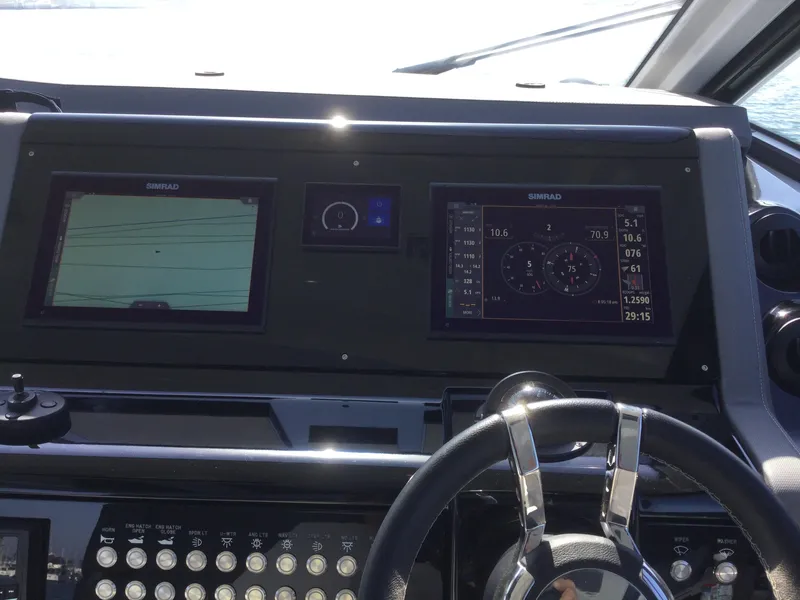 Slide: The Image of Dashboard of 2021 Cruisers Yachts 42 GLS OB with navigation screens and controls. - 21