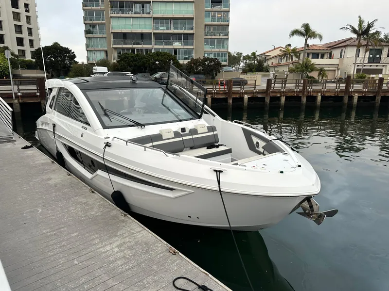 Slide: The Image of 2021 Cruisers Yachts 42 GLS OB docked near waterfront buildings. - 26