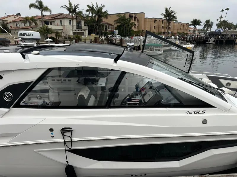 Slide: The Image of 2021 Cruisers Yachts 42 GLS OB docked near waterfront homes. - 28