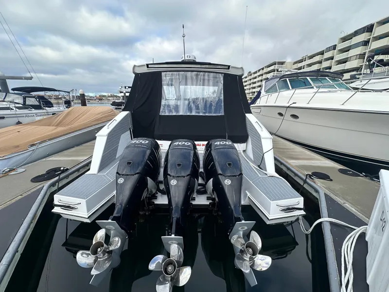 Slide: The Image of 2021 Cruisers Yachts 42 GLS OB with triple outboard engines docked at marina. - 29