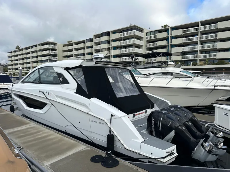 Slide: The Image of 2021 Cruisers Yachts 42 GLS OB docked at marina, modern design, outboard engines visible. - 30